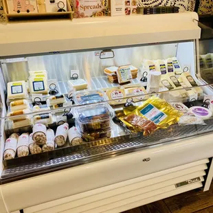 a display case with a variety of baked goods