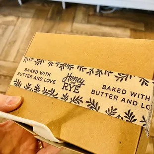a hand holding a box of butter and almond