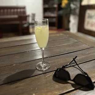 a glass of wine and sunglasses
