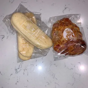 Cheese flatbread on the left and a hotdog with bread