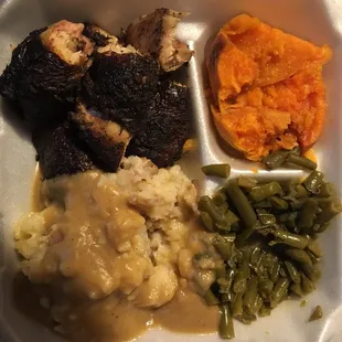 Jerk chicken, candy yams, green beans, and mashed potatoes w/ gravy.