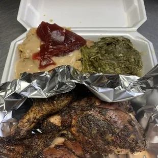 Jerk chicken dinner served with dressing and turnip n' mustard greens
