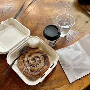 Cinnamon roll, coffee, old wood table