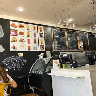 a woman sitting at a table in a cafe