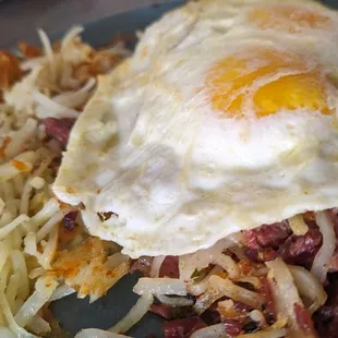 Corned beef hash, hashbrowns, and two eggs.