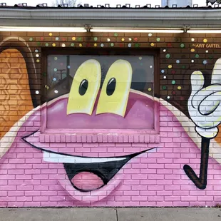 a brick building with a mural on it