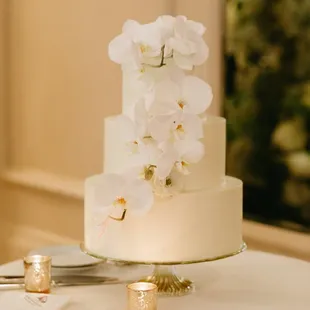 Smooth buttercream cake with cascading orchids. Image courtesy of Kelly Kang Photography.