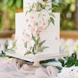 Delicate sugar flowers and climbing vines on a square cake, textured with wafer paper. Image courtesy Courtney Bowlden Photo.