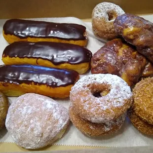 Dozen donuts - blueberry, vanilla cream, dutch crumb, toasted coconut, apple fritters and chocolate long john&apos;s.