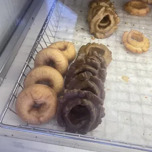 a variety of donuts in a display case