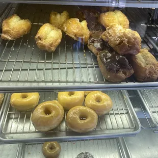 a variety of donuts in a display case