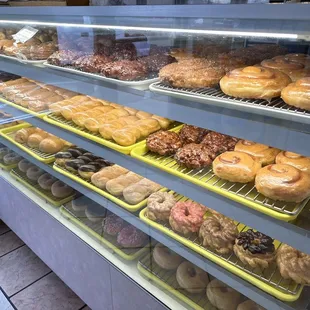 a variety of donuts in a display case