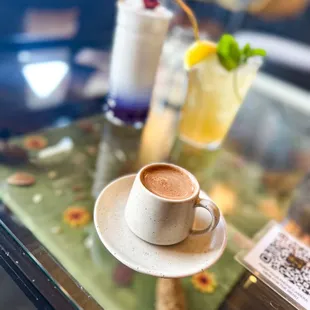 a cup of coffee on a glass table