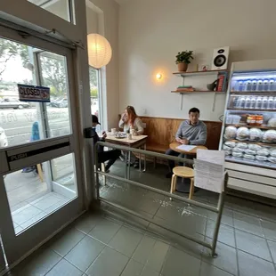 two people sitting at a table in a coffee shop