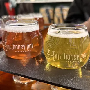 three glasses of beer on a bar