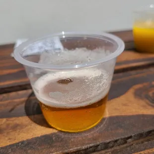 a glass of beer on a wooden table