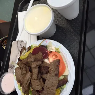 a plate of food and a drink on a tray