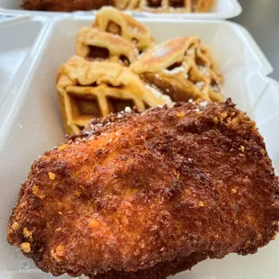 fried chicken and waffles in a styrofoam container