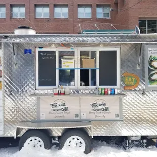 a food truck parked in the snow