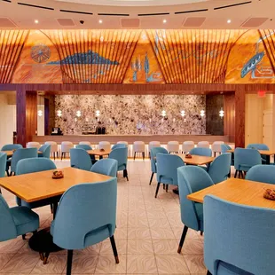 a restaurant with blue chairs and tables