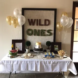 a dessert table with balloons