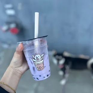 a hand holding a cup of bubble tea