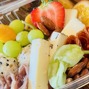 a variety of cheese, fruit, and nuts