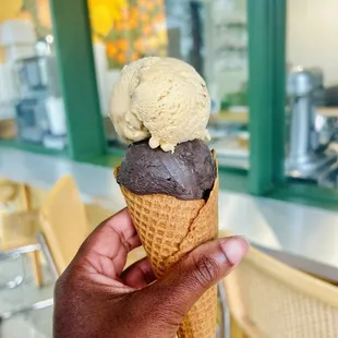 Sweet corn cone with 2 scoops (one darkest chocolate) + indoor outdoor seating in the background