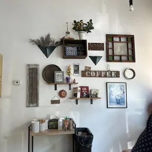 a coffee shop with various items on the wall