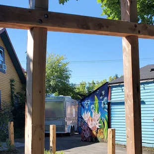 a view of a street through a wooden frame