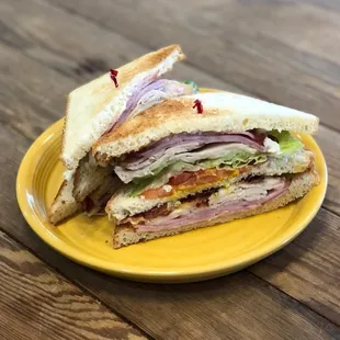 a sandwich on a yellow plate