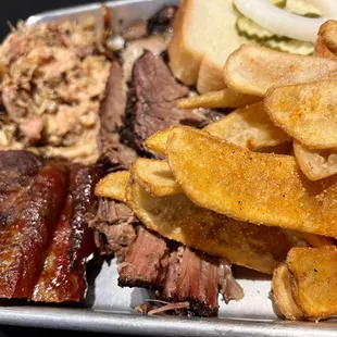 a platter of meat and fries