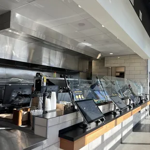 Order via screens, food is prepared on the left side of this picture