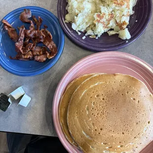 Two pancakes and bacon , side of home fries