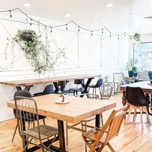 a dining room with wooden tables and chairs