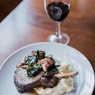 a plate of food and a glass of wine