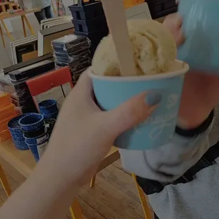 a person holding a cup of gelato