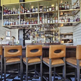 a row of bar stools at a bar