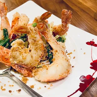 a plate of fried shrimp and greens