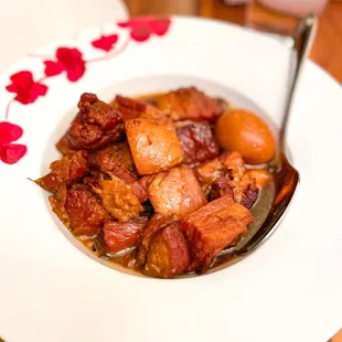 a bowl of stew with a spoon
