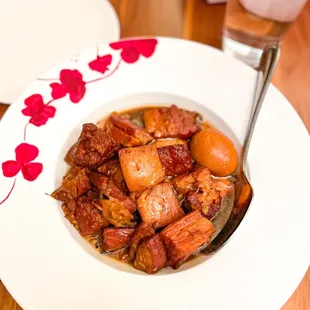 a bowl of stew and a glass of water