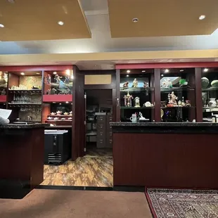 a woman standing at a counter in a restaurant