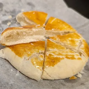 a piece of bread on a piece of wax paper