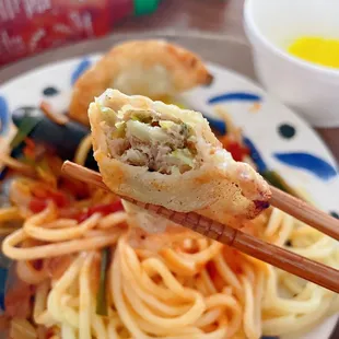 a plate of food with chopsticks