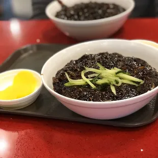 two bowls of food on a tray