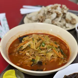 a bowl of soup and a plate of rice