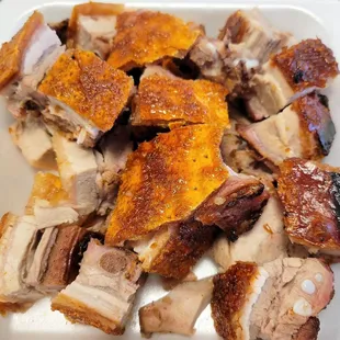 a plate of pork and ribs