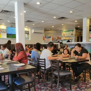a large group of people eating in a restaurant