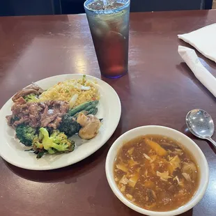 a bowl of soup and a plate of broccoli