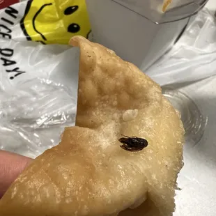 a hand holding a piece of food